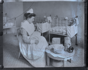 Historic photo shows nurse caring for blind infant.