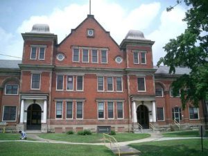 The front of the Mayview Building, brick, three stories with a wide lawn before it