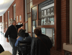 Photo of people looking at hallway display