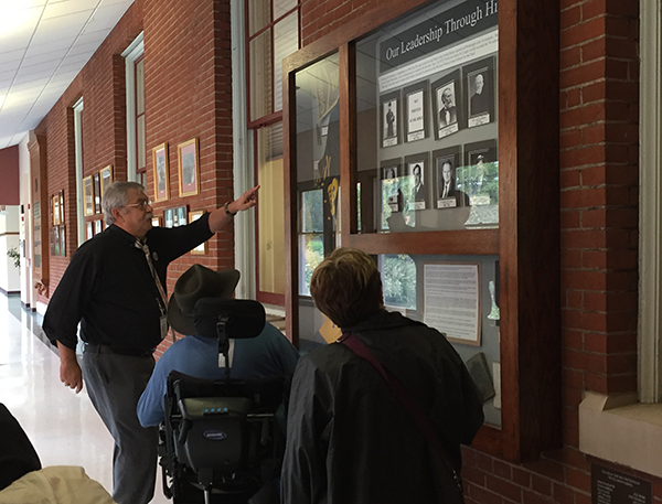 Photo of people looking at hallway display