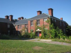 Photo of Fernwald State School with overgrown vegetation