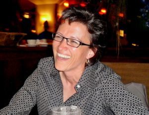 Mary Brougher smiling while seated at a table