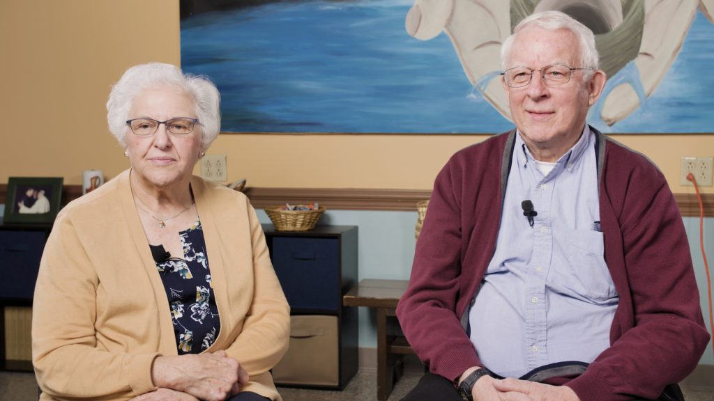Photo shows Mary Ann Zarnick and Father George Strohmeyer, seated for their interview.