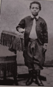 Henry C. Bell, standing beside a chair