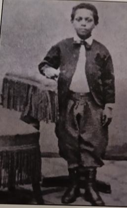 Henry C. Bell, standing beside a chair