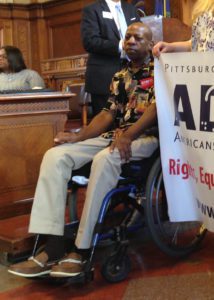 Milton "Skip" Henderson, seated in his wheelchair