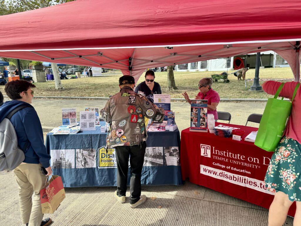 Cindy Leonard and Tina Calabro greet multiple visitors to the Consortium's table.