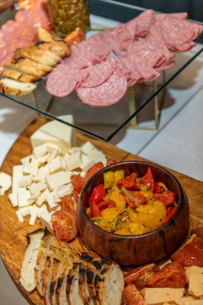 A food spread of meats, cheeses, and veggies.