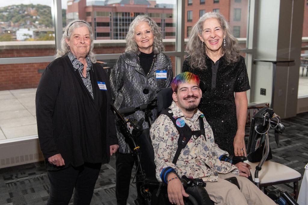 Ann Talman and Mark Steidl pose for a photo with two guests.