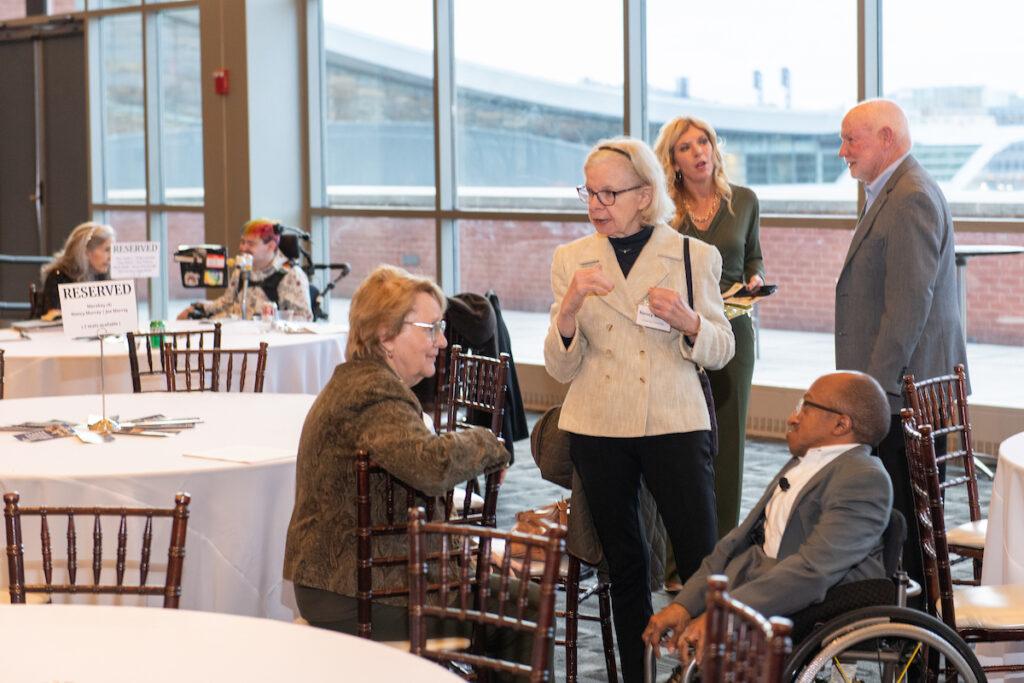 Guests chatting with Chaz Kellem, emcee.