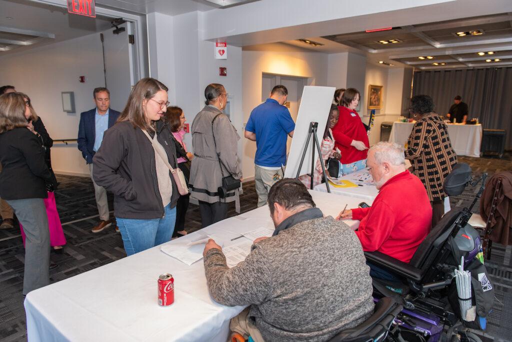 People checking in at the registration desk.