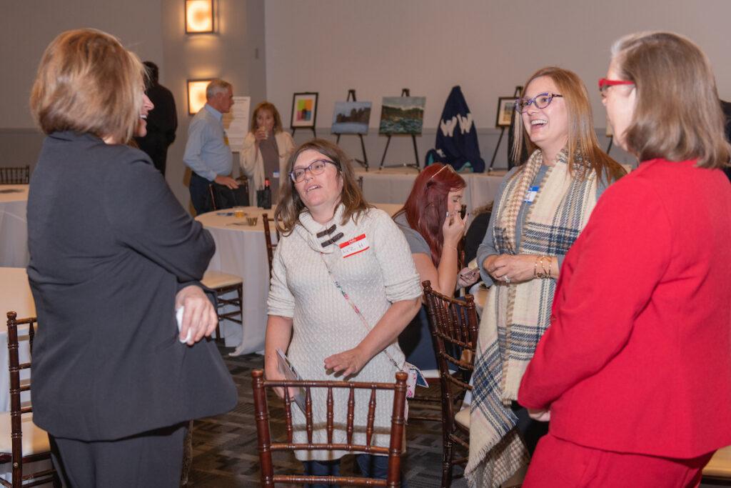 Four women chatting during the reception.