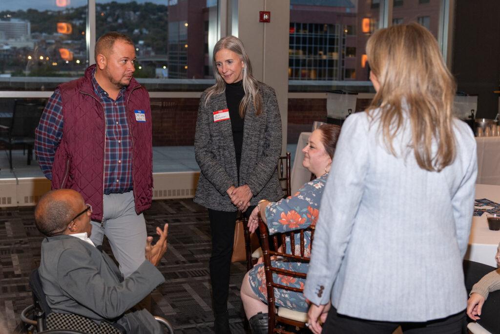 Emcee Chaz Kellem chats with three women and one man.