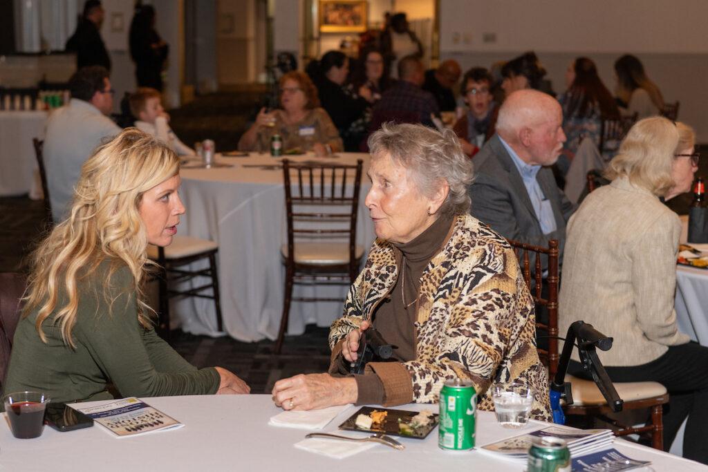 Ginny Thornburgh chatting with an event volunteer.