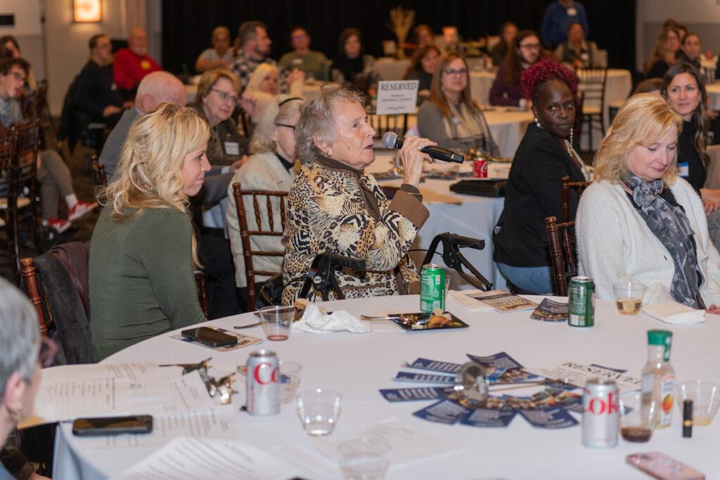 Audience Q&A with Ann and Mark. Ginny Thornburgh is speaking into the handheld microphone being passed around.