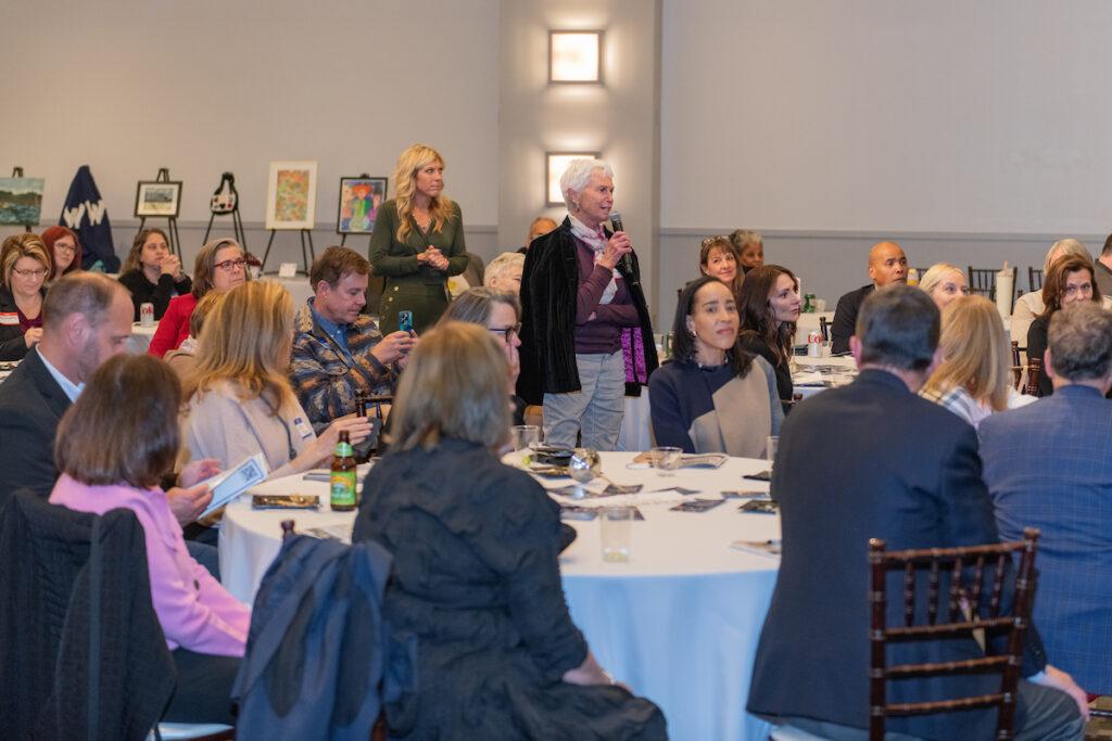 Audience Q&A with Ann and Mark. A woman is speaking into the handheld microphone being passed around.