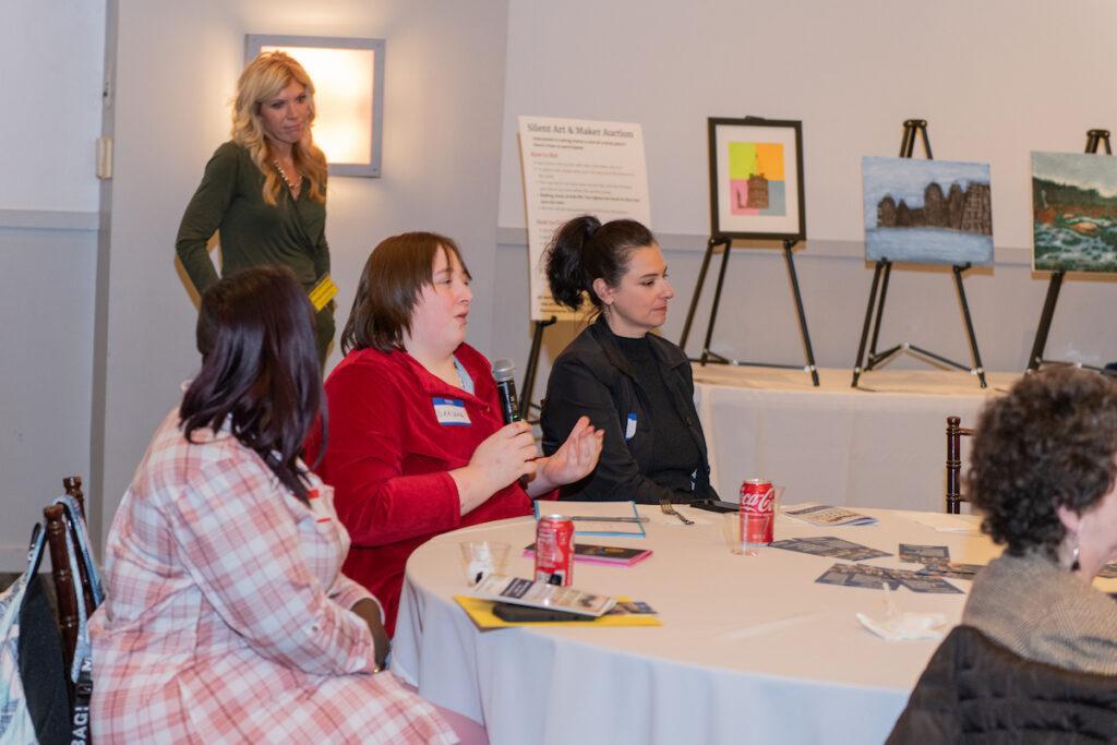 Audience Q&A with Ann and Mark. A woman is speaking into the handheld microphone being passed around.