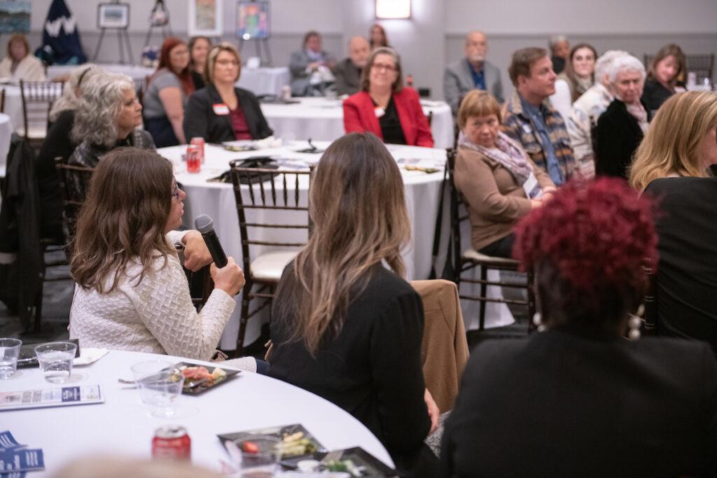 Audience Q&A with Ann and Mark. A woman is speaking into the handheld microphone being passed around.