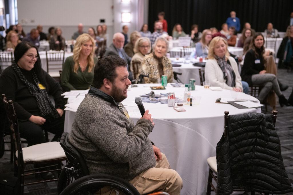 Audience Q&A with Ann and Mark. A man is speaking into the handheld microphone being passed around.