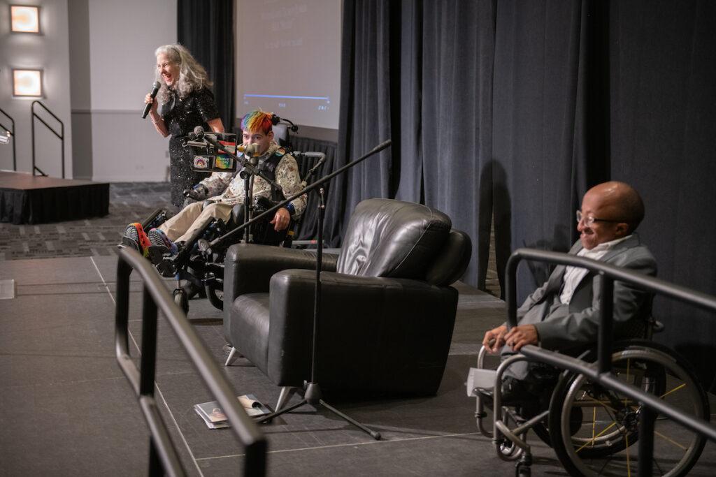 Ann and Mark on stage with Chaz in the wings.