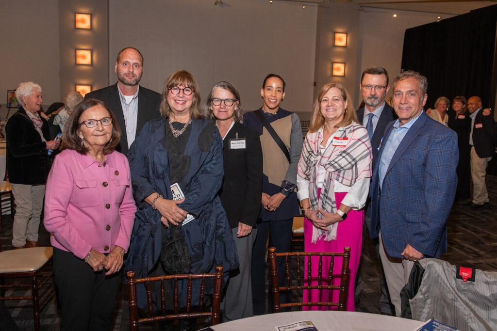 A group of sponsors pose for a photo - five women and three men.