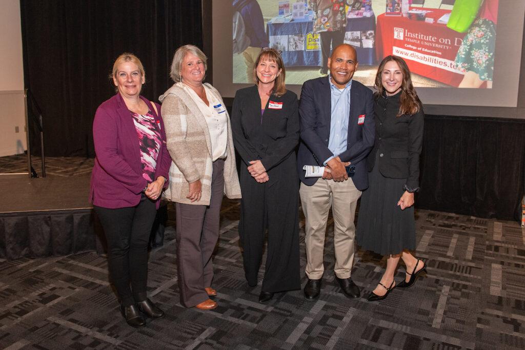 A group of sponsors pose for a photo - four women and one man.