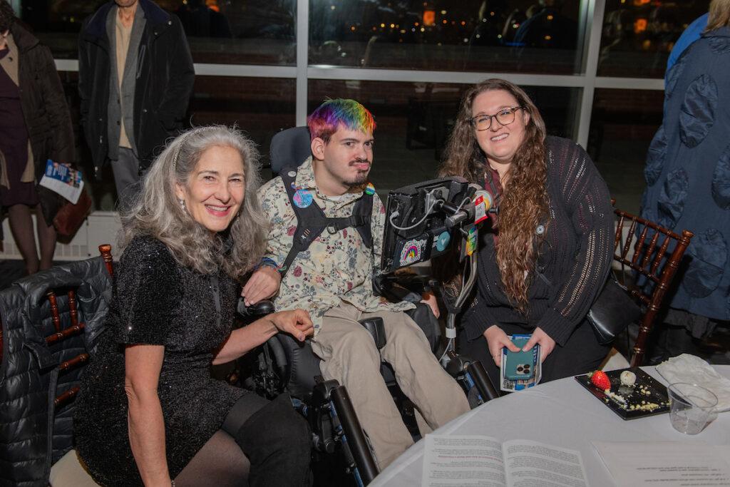 A woman chats with Ann Talman and Mark Steidl.