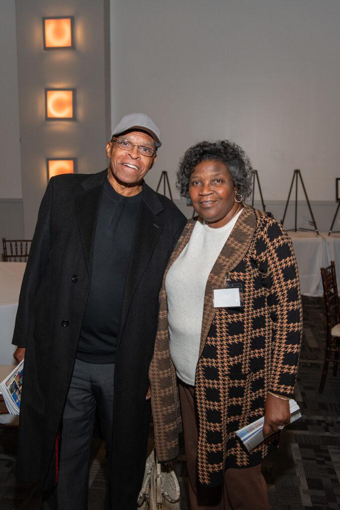 An event volunteer poses for a photo with her husband.