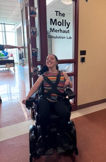 Molly Merhaut poses for a photo in front of the entrance to the Lab. Photo courtesy of Myah Werkmeister.
